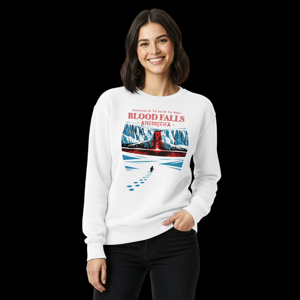 Woman wearing white 17th & Surf Blood Falls Antarctica sweatshirt featuring penguin walking toward red waterfall beneath icy cliffs